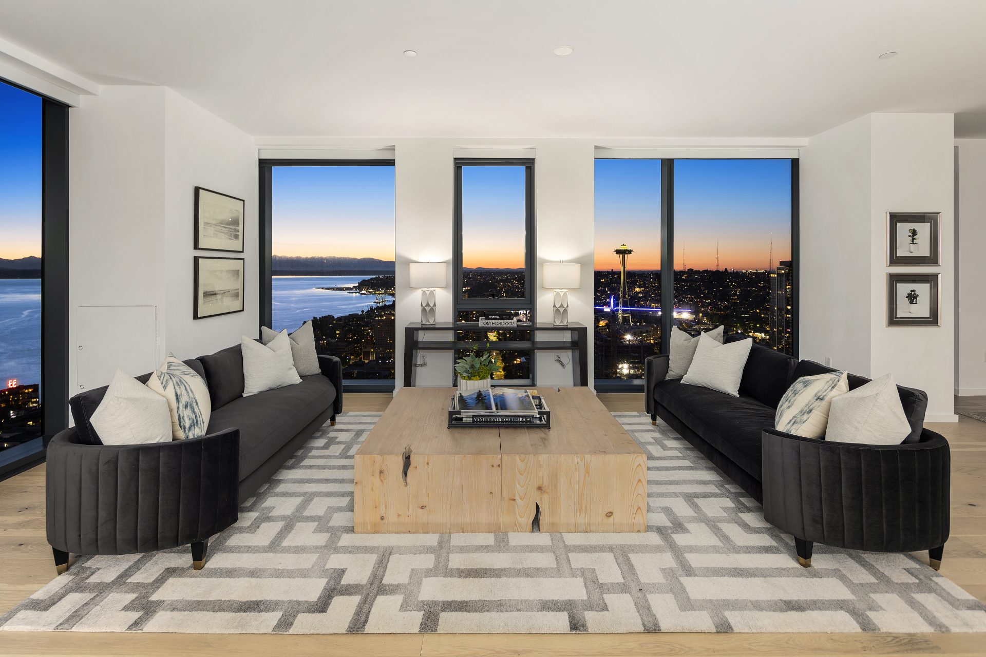 floor to ceiling windows frame sweeping views of downtown seattle and elliott bay