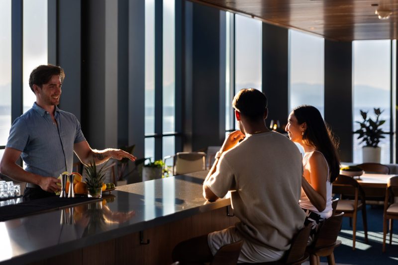 Bartender greeting guests at private rooftop bar